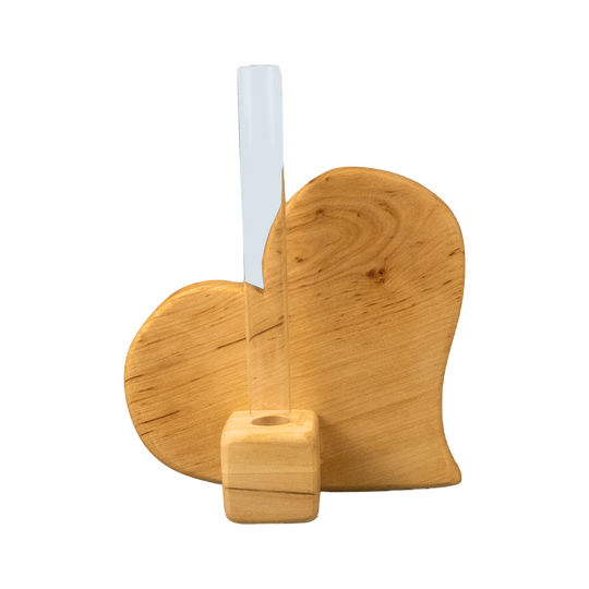 Holzvase in Herzform mit natürlicher Maserung, in deren Mitte ein schmales Glasröhrchen für einzelne Blumen steckt, vor weißem Hintergrund von hinten fotografiert